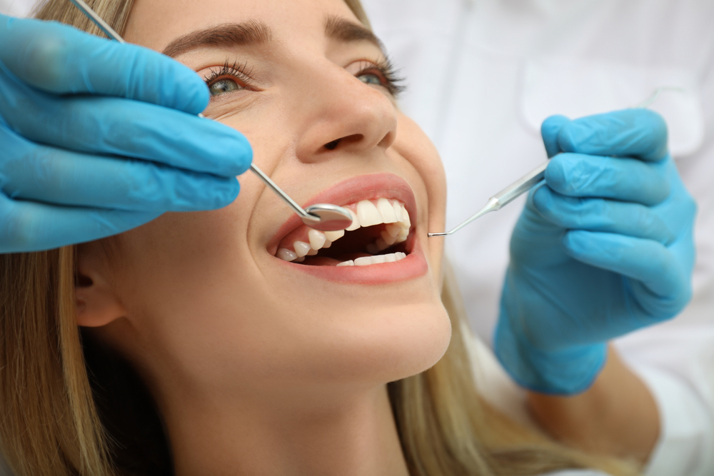 smiling patient gets a dental exam