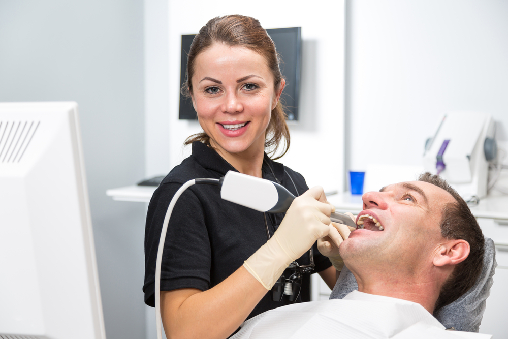 Dentist scanning patient's teeth
